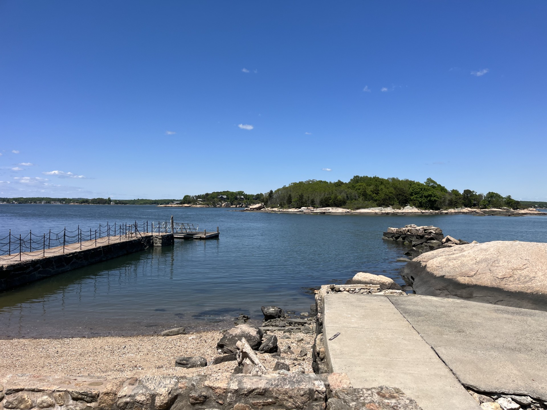 Man sitting on pier reading measurement device